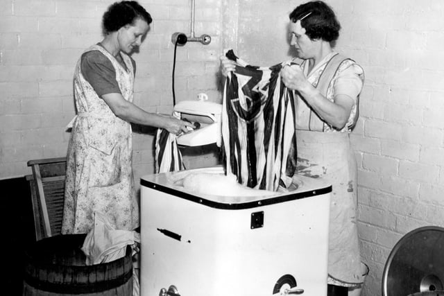 Mrs Edith Adams, left and Mrs K.Leeks washing the shirts of Sheffield Wednesday footballers - they now have an electric washing machine to lighten their work