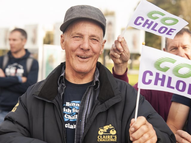A fan cheers on runners during the Great South Run 5km on Saturday. Photo: David Tiller