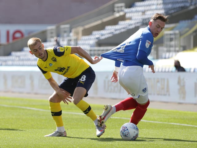 Pompey's Ronan Curtis breaks free of Mark Sykes of Oxford United