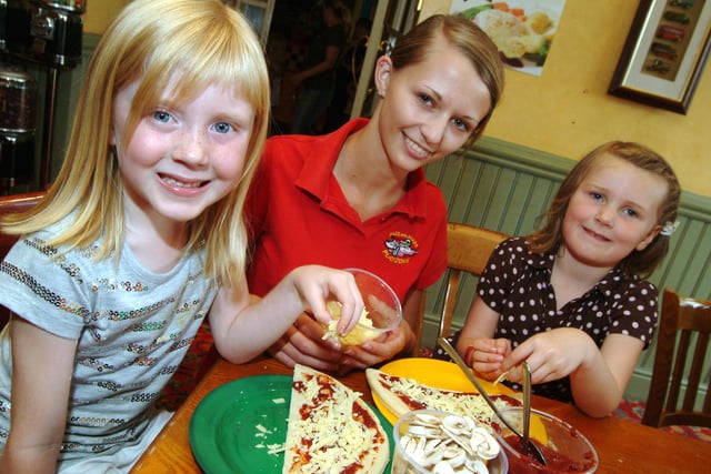 Members of 4th Sutton Rainbows, 5th Sutton Brownies and 1st Sutton Brownies were invited to The King and Miller in Sutton in 2009 for a free pizza making and play session. Pictured are Rainbows Rosie Leech 6, left and Elle Thompson 5, right with Playzone Crew member Andrea Bunting, centre making pizza.