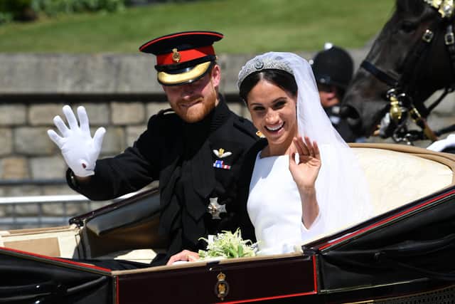 Prince Harry and Meghan Markle ride in an Ascot Landau after their wedding ceremony at St. George's Chapel in Windsor Castle.