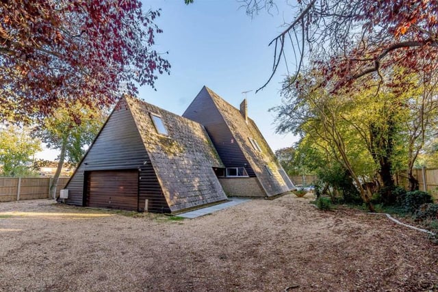 The external appearance and triangular shape of the Littlehampton house are clearly its most eyecatching assets, especially as the building is set in a woodland-type garden. Look how the double garage is almost wedged beneath one of the bedrooms.