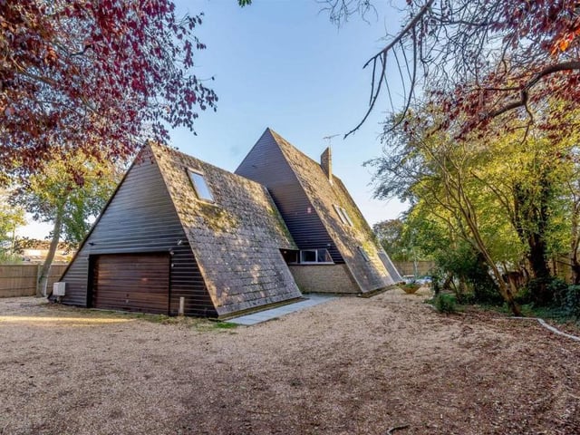 The external appearance and triangular shape of the Littlehampton house are clearly its most eyecatching assets, especially as the building is set in a woodland-type garden. Look how the double garage is almost wedged beneath one of the bedrooms.