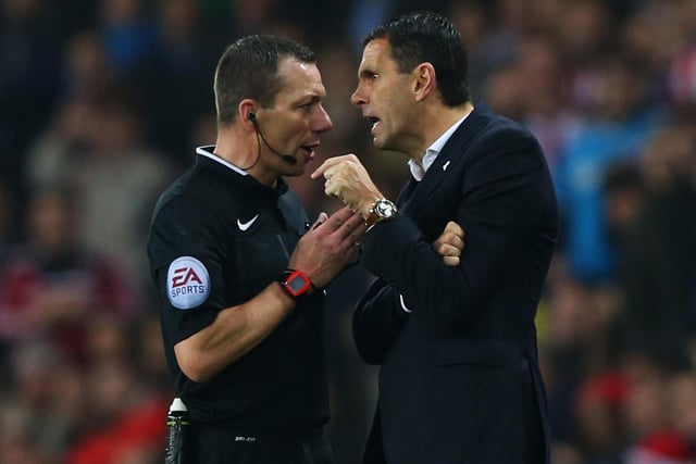 Referee Kevin Friend in discussion with Gustavo Poyet as he dismisses assistant Mauricio Taricco during the Barclays Premier League match between Sunderland and Chelsea at Stadium of Light on November 29, 2014.