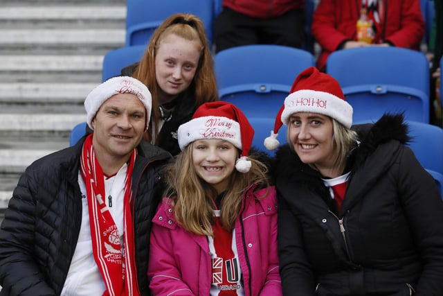 United fans get into the Christmas spirit at Brighton & Hove Albion's Amex Stadium in December 2019.
