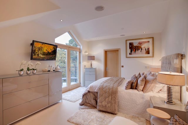 The master bedroom suite has recessed lighting, an extractor fan, provision for a wall mounted TV and under floor heating. To one corner, there’s a range of fitted furniture. Again, double oak doors with glazed panels open to the balcony.