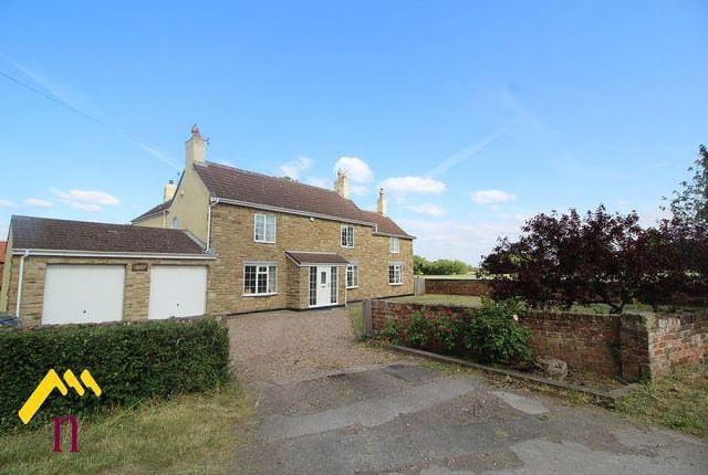 This four bedroom has outhouses and an outdoor swimming pool.