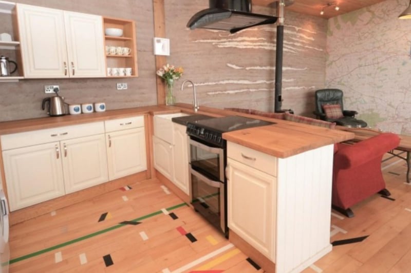 The open plan living area includes a well-appointed kitchen.