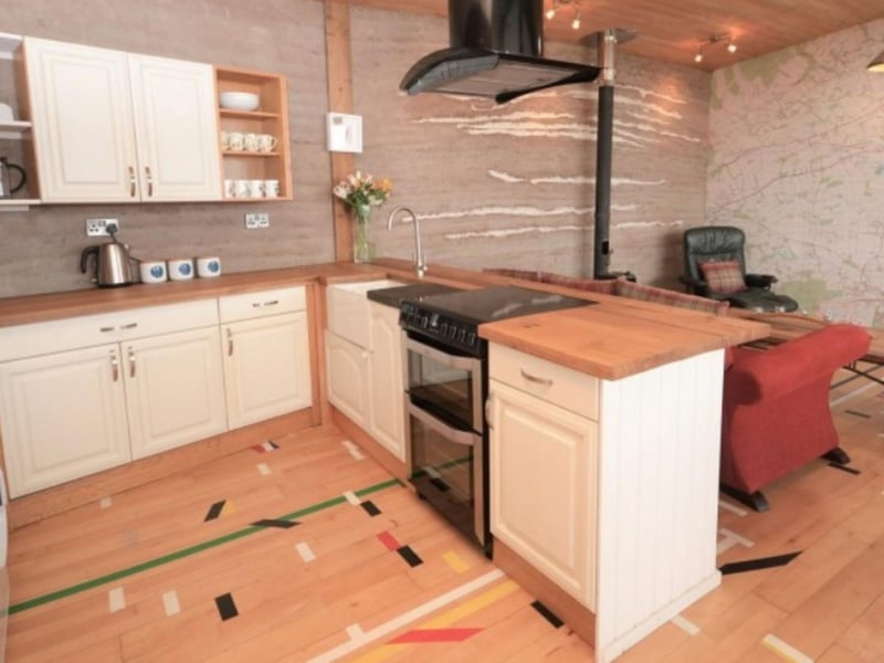 The open plan living area includes a well-appointed kitchen.