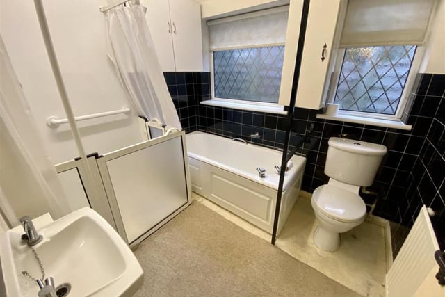 The bathroom is a four-piece suite, comprising a panelled bath, walk-in shower, wash hand basin and low-flush WC. There are two cupboards, a radiator and a uPVC window to the side.