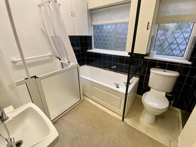 The bathroom is a four-piece suite, comprising a panelled bath, walk-in shower, wash hand basin and low-flush WC. There are two cupboards, a radiator and a uPVC window to the side.