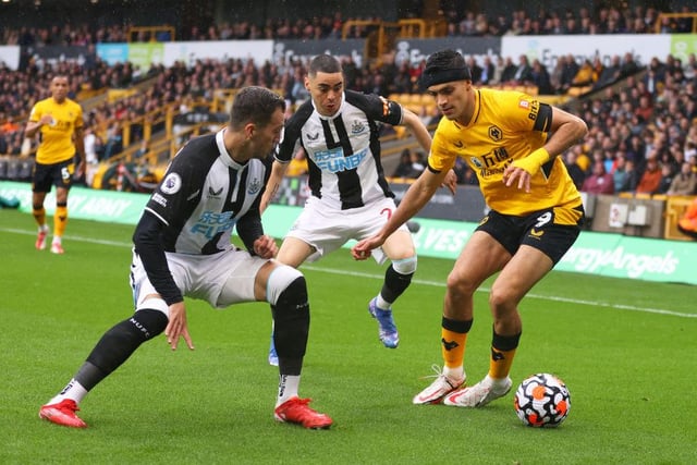 Raul Jimenez of Wolverhampton Wanderers is closed down by Javier Manquillo and Miguel Almiron of Newcastle United during the Premier League match between Wolverhampton Wanderers and Newcastle United at Molineux on October 02, 2021 in Wolverhampton, England.