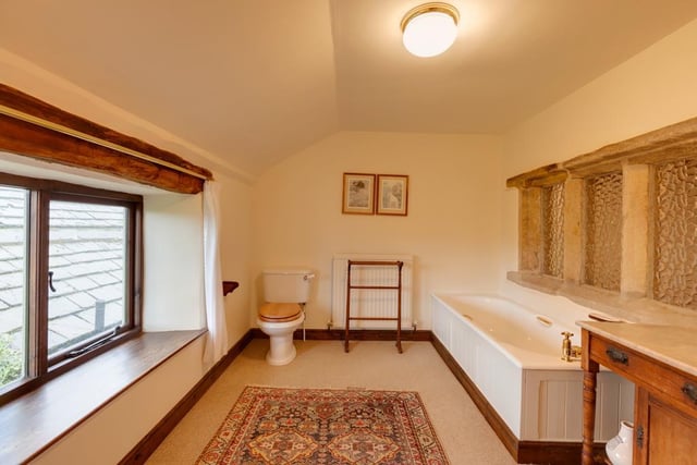 The master bedroom's en-suite bathroom has a panelled tub and a separate shower enclosure.
