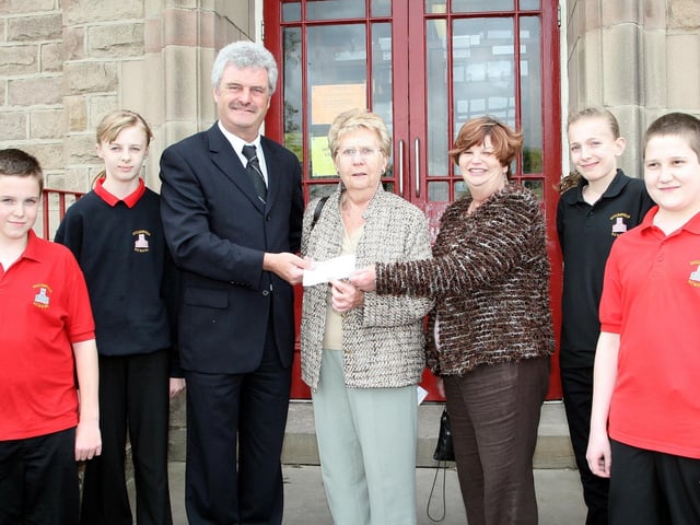 Ecclesfield School Headteacher Mick Nolan, along with pupils, presents a cheque for £500 to Pam Prior & Heather Johnson for cows in Bangalore, May 2007.