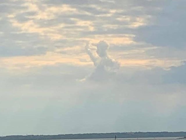 This is an odd one. Joseph Purtill was in the right place at the right time to capture a cloud that looked like a person wearing a baseball cap and a back pack off the coast of Southsea.