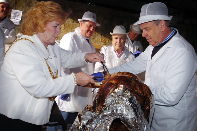 The Mayor of Sunderland, counc Norma Wright helps members of the Rotary Club serve up the first ox roast sandwich at the 2011 Houghton Feast.