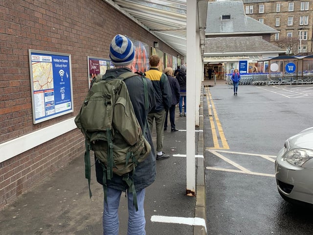 Shoppers clearly abiding to social distancing rules when queuing up outside Tesco in Broughton Road, Edinburgh.