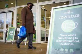 Face coverings are mandatory for most people in indoor public spaces such as shops and on public transport. Picture: Dominic Lipinski/PA