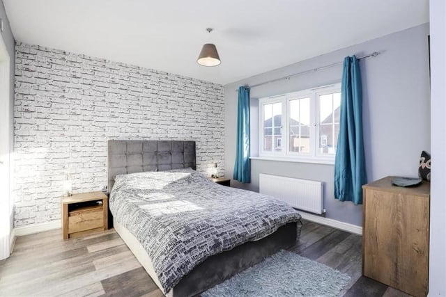 The master bedroom is a classy space, offering laminate flooring, a wall-mounted radiator, a uPVC double-glazed window overlooking the front of the property, and also access to en suite facilities.