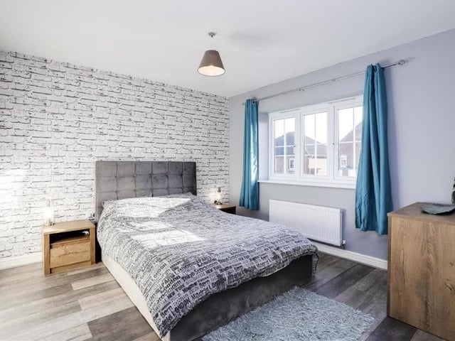 The master bedroom is a classy space, offering laminate flooring, a wall-mounted radiator, a uPVC double-glazed window overlooking the front of the property, and also access to en suite facilities.