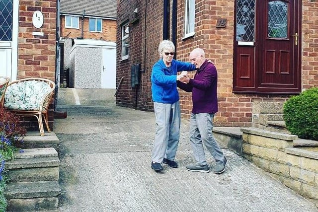 DJ David Hector has been holding a socially-distanced disco on Sandstone Close, Wincobank, where he lives - residents are pictured waltzing on their drive.