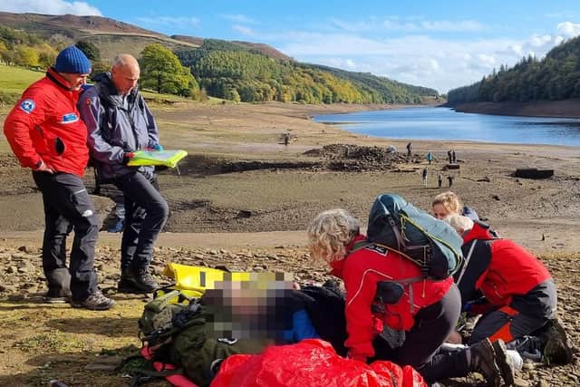 Members of Edale Mountain Rescue are pictured helping a stricken walker in the mud at the Ladybower reservoir. PIctures: Edale Mountain Rescue
