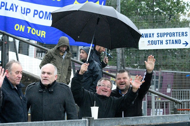 Supporters in the lashing rain at Bristol Rovers