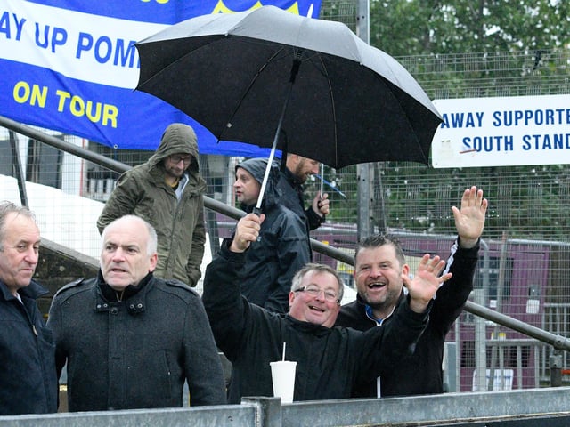 Supporters in the lashing rain at Bristol Rovers