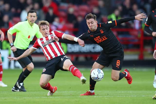 Ben Osborn of Sheffield United tackles Ryan Wintle of Blackpool: Simon Bellis/ Sportimage