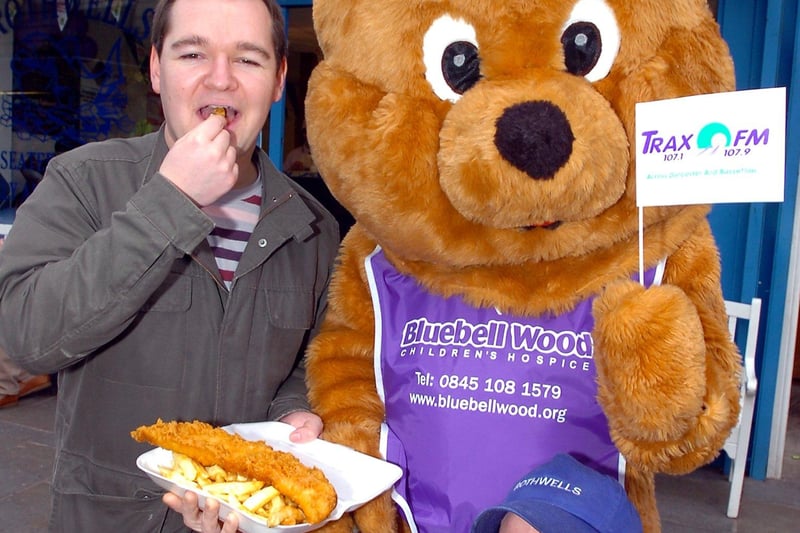 Trax FM disc jockey  Vic Hancock, who drew a Bluebell Wood Children's Hospice raffle to win free fish and chips for a year, is pictured with Bella the Bear and David Rothwell of Rothwell's chip shop in Doncaster