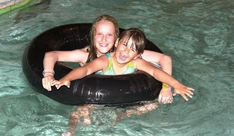 Sisters Stephanie and Nicole Stokes enjoying a swim in 2001.