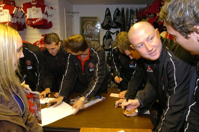 United players - including goalkeeper Paddy Kenny - sign autographs for fans during the club's Christmas party at Bramall Lane in December 2005.