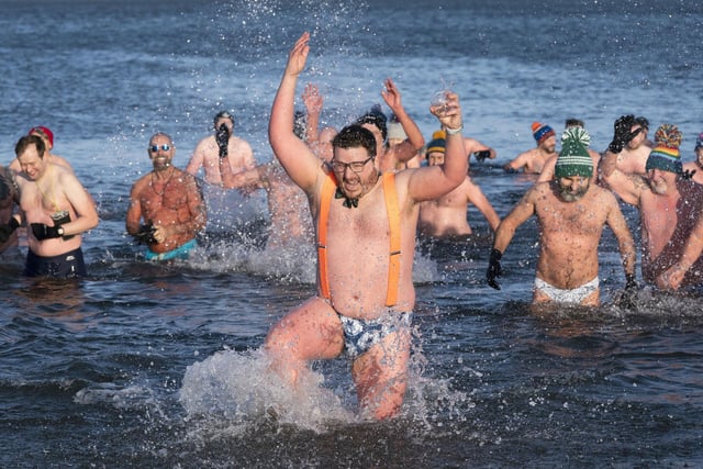People swim and take a dip in the Firth of Forth at Portobello Beach in Edinburgh on New Year's Day. Picture date: Saturday January 1, 2022. PA Photo. Photo credit should read: Jane Barlow/PA Wire