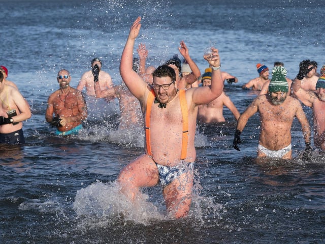 People swim and take a dip in the Firth of Forth at Portobello Beach in Edinburgh on New Year's Day. Picture date: Saturday January 1, 2022. PA Photo. Photo credit should read: Jane Barlow/PA Wire