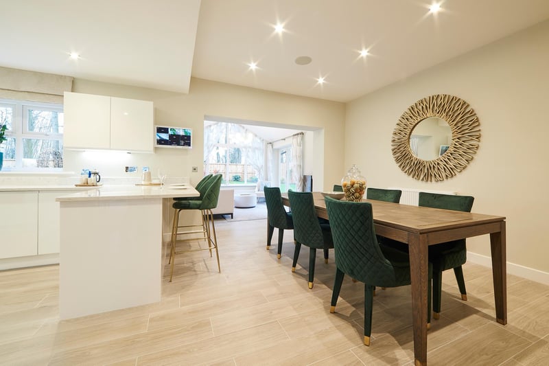 Lucy says: “The Knightsbridge II enjoys a spacious open-plan kitchen and family area, located at the rear of the property, which is both luxurious yet family-oriented. The light wood-effect floor contrasts nicely with the emerald-green dining chairs to match the overall contemporary design of the room.”