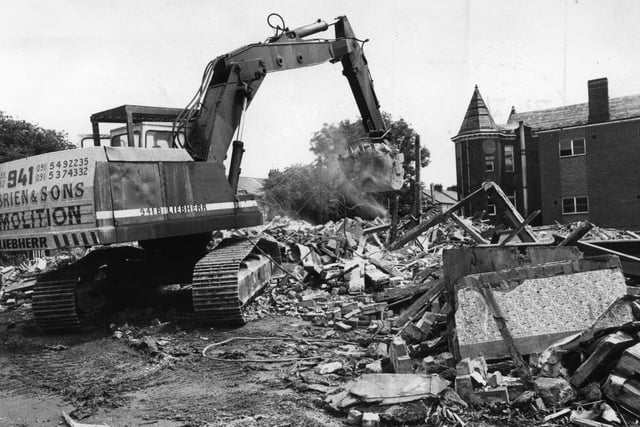 A digger clears another load of bricks and mortar away from the Ingham Infirmary which was to make way for housing.