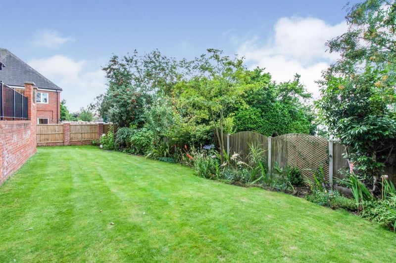 Rear garden  with generous mainly laid to lawn rear garden with shrubs and plants to the borders.