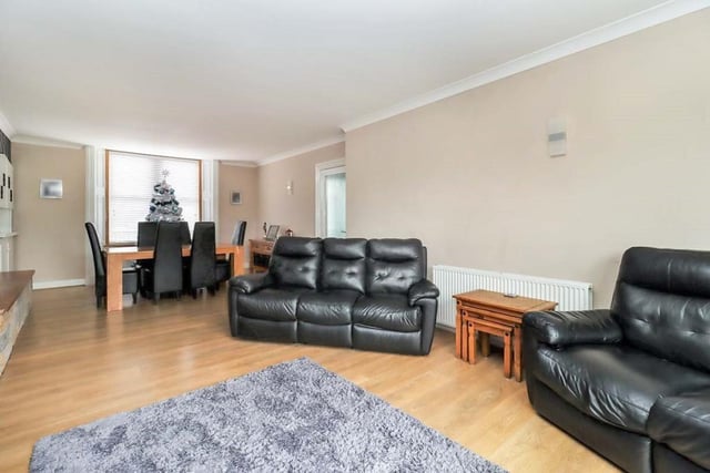 The fantastic open plan living room extends to almost nine metres and is a great family space with feature fireplace, patio doors out to the rear garden, and separate dining area.