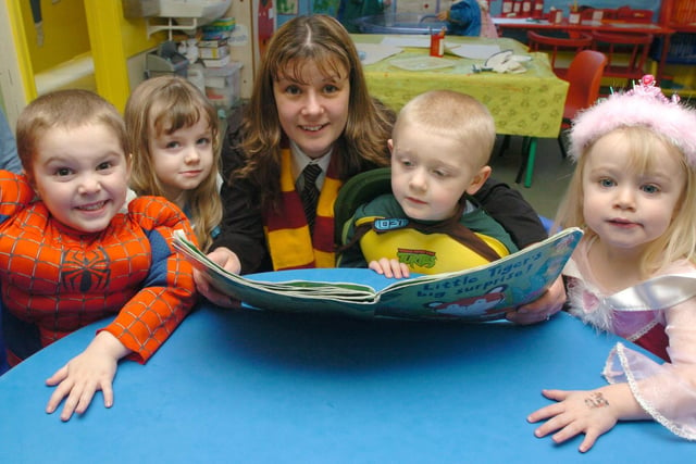 Michelle Williams read a book to tots  Alex Scriven, Emily Barber, Dominic Moyle and Yasmine Connor at the Small World Nursery's  national book day celebrations in 2005