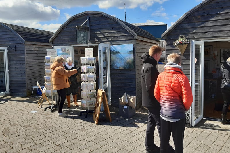 Shoppers browsing at Amble Harbour Village.