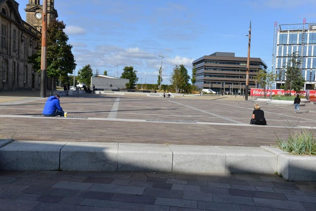 A handful of people out at Keel Square on Friday afternoon.