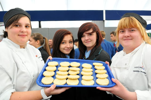 Hartlepool College of FE catering students Danielle Thomas (left) and Charlotte Prosser offer a cake to Dyke House Sports and Technology College pupils Jessica Payne and Ashlyn Pell (centre right). Who can tell us more about this 2013 scene?
