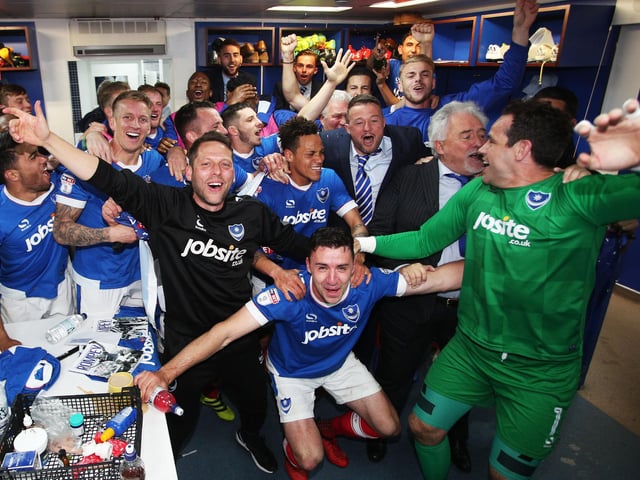 Pompey players and staff celebrate the triumph.