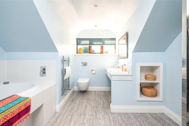 The generously-sized family bathroom is equipped with twin wash basins, a low flush WC, a bath and walk-in shower cubicle, and there are three further bathrooms throughout the home.
