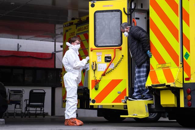 A man with an unknown condition is helped from an ambulance at the St Thomas' Hospital (Photo by Justin Setterfield/Getty Images)