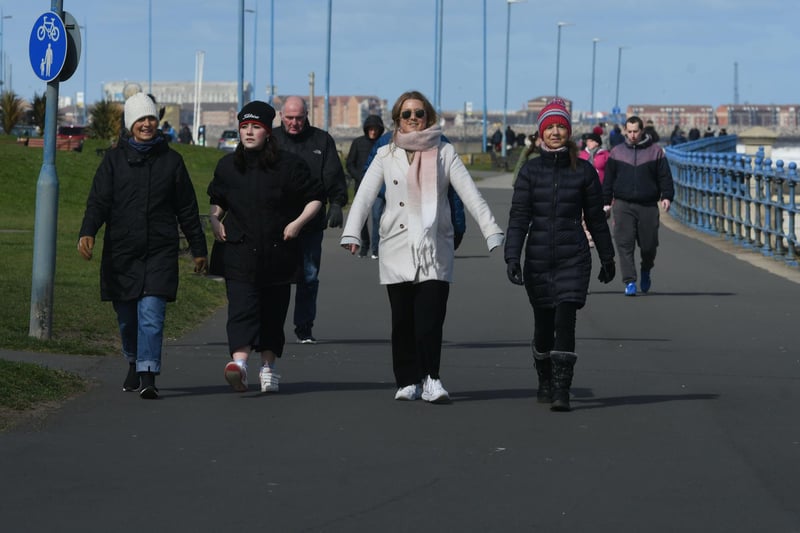 Walkers out on Seaton Carew seafront, dressed for the elements.