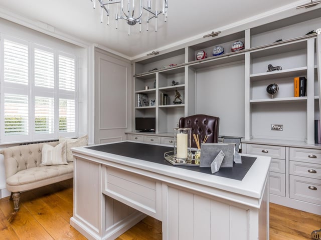 The study has been fitted with a bespoke range of fitted furniture to include shelving, cupboards and drawers.