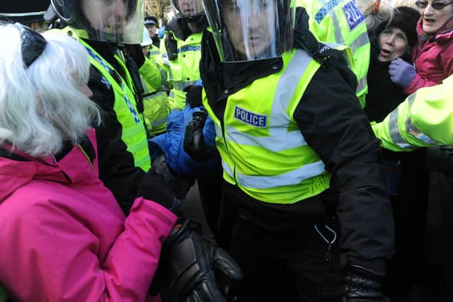 8 March 2018....... Tree protests on Kenwood Road in the Nether Edge area of Sheffield today. A protester is arrested after being forcefully removed from under a contractor's truck and stopping felling from taking place. Picture Scott Merrylees