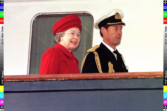 The Queen and Commodore Anthony Morrow,  Britannia's commanding officer, aboard The Royal Yacht Britannia in Portsmouth before the vessel was paid off after 44 years of service .