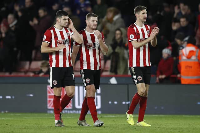 John Egan, Jack O'Connell and Chris Basham of Sheffield United applaud the fans following a Premier League match at Bramall Lane, Sheffield. Picture date: 14th December 2019. Picture credit should read: Simon Bellis/Sportimage